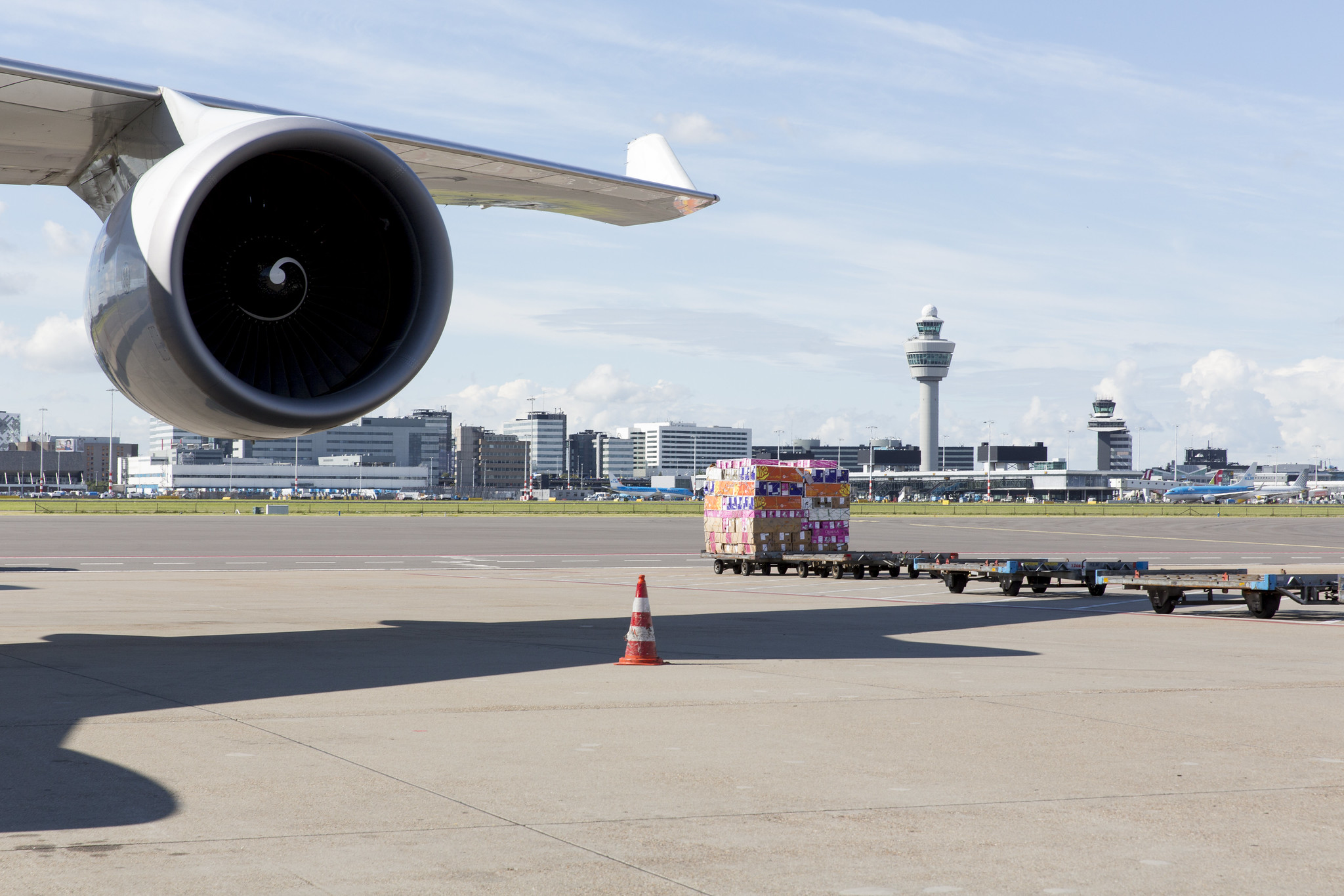 An aircraft engine and wing on the apron at Amsterdam Schiphol